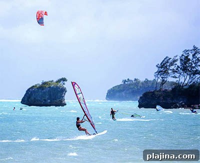 Windsurfers and kiteboarders enjoying wind power on Bulabog Beach
